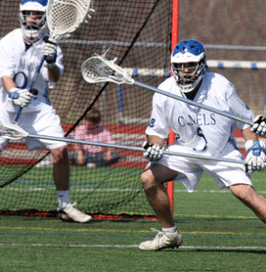 Conn College goalie, Mark Moran (background), will be missed by the Camels